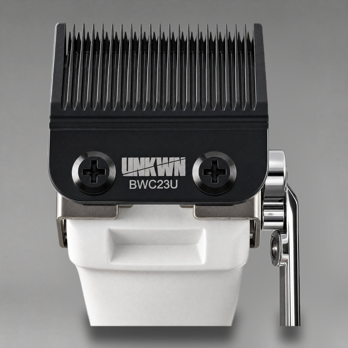 Close-up of the UNKWN Cyclone Clipper cutting head in white, showing the BWC23U DLC fade blade and chrome taper lever