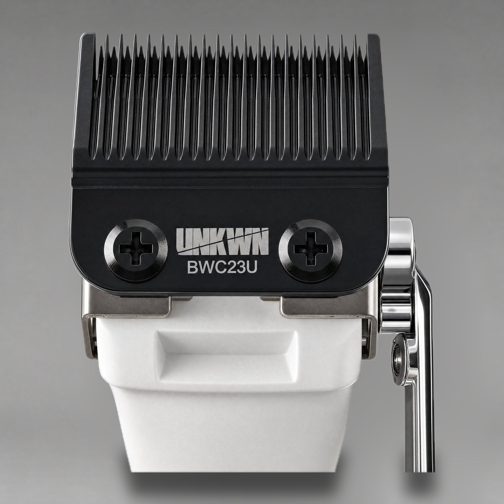 Close-up of the UNKWN Cyclone Clipper cutting head in white, showing the BWC23U DLC fade blade and chrome taper lever
