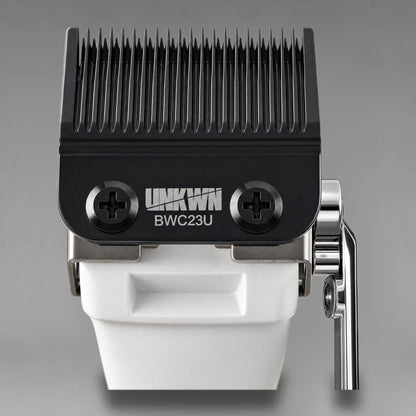 Close-up of the UNKWN Cyclone Clipper cutting head in white, showing the BWC23U DLC fade blade and chrome taper lever