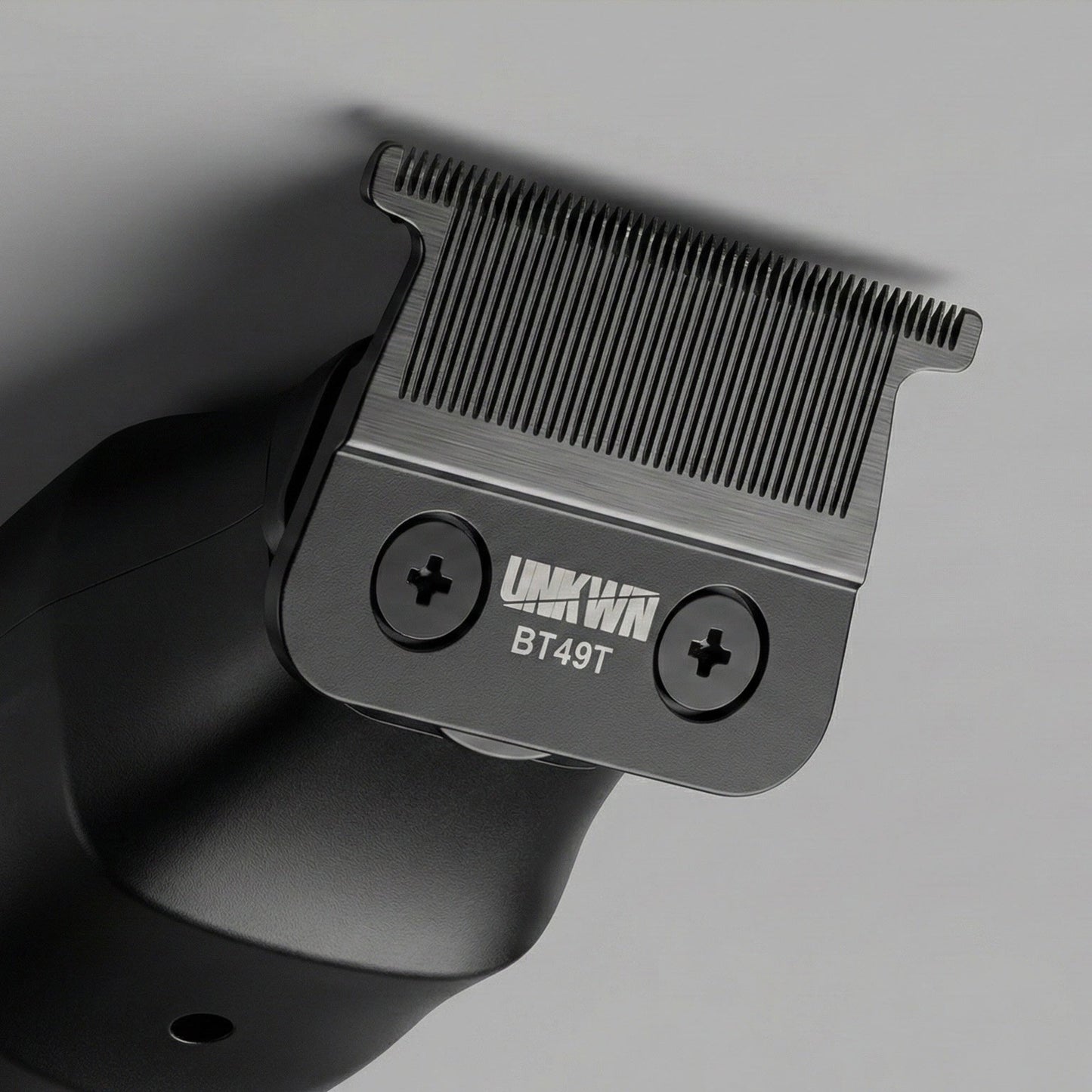 Close-up of the zero gap T blade on the UNKWN Vortex Cyclone Trimmer, showing the two mounting screws