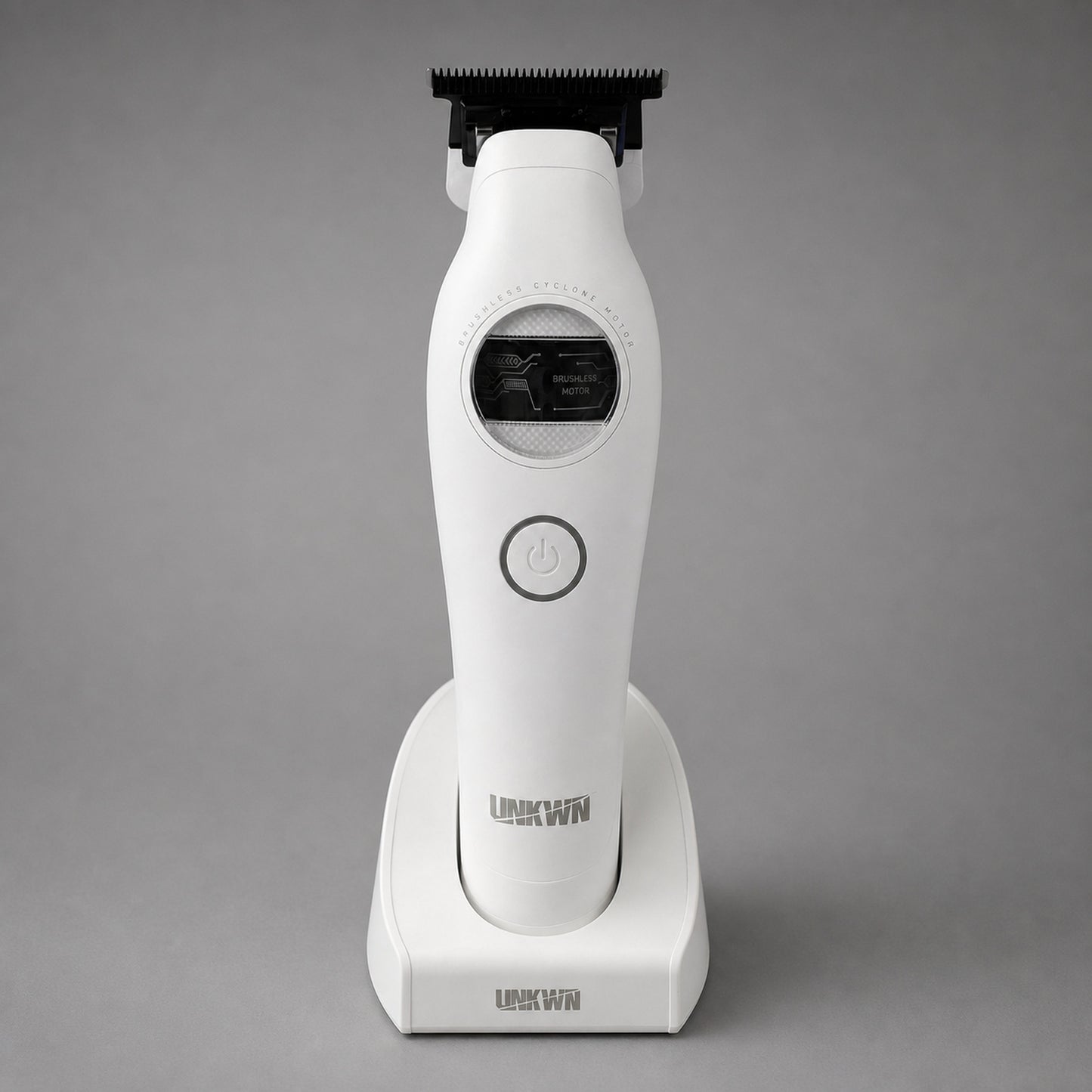 UNKWN Cyclone Trimmer UNK1T in white, front view in its charging dock