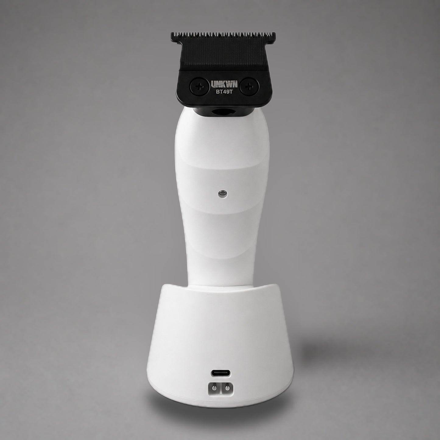 Rear view of the white UNKWN Vortex Cyclone Trimmer, showing the BT49T blade, rear indicator and charging dock ports