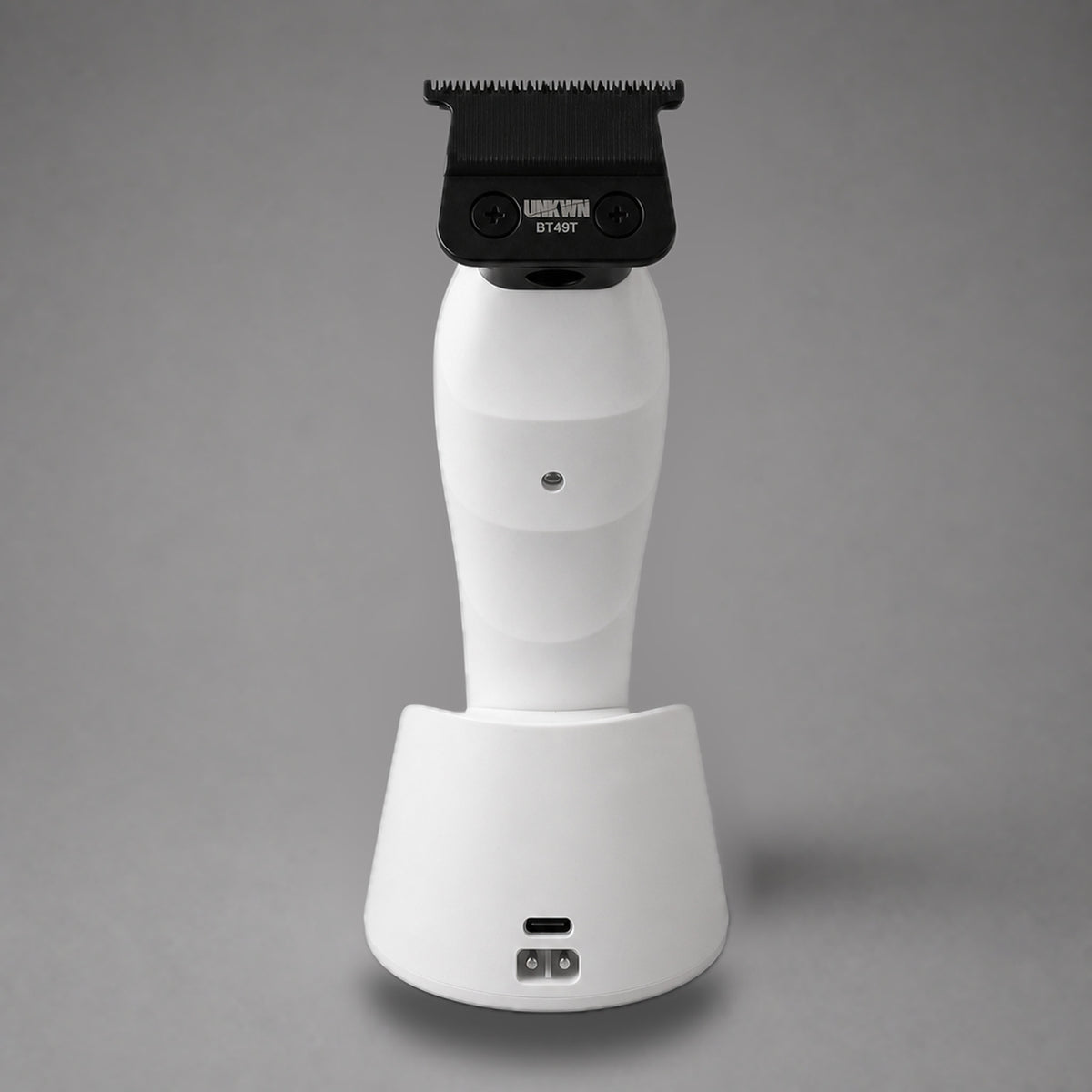 Rear view of the white UNKWN Vortex Cyclone Trimmer, showing the BT49T blade, rear indicator and charging dock ports