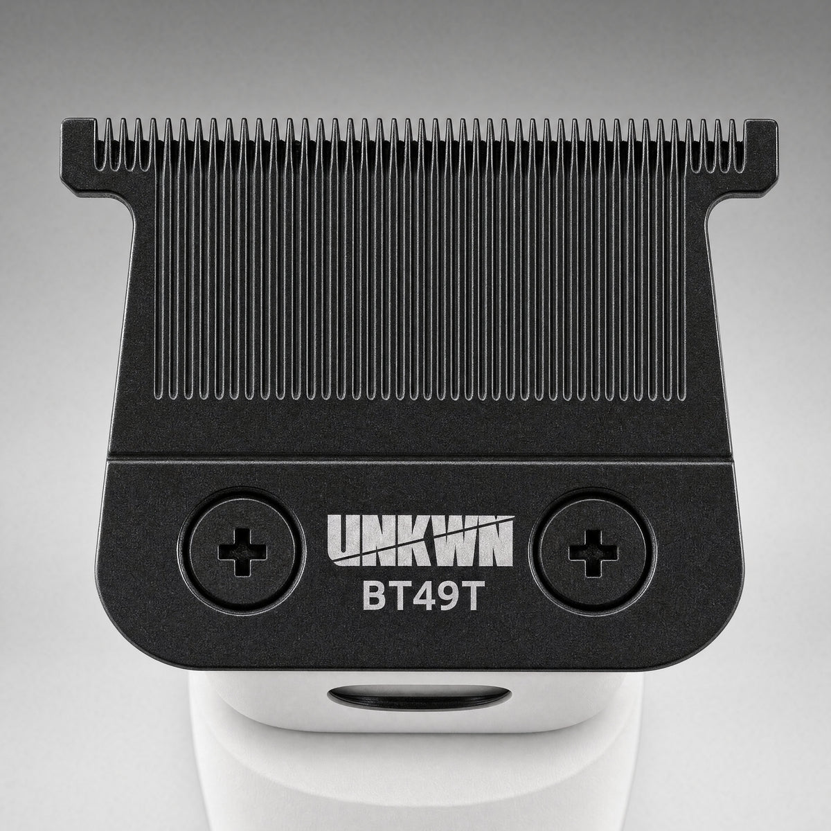 Close-up of the UNKWN Cyclone Trimmer T-blade in white, showing the BT49T zero-gap blade